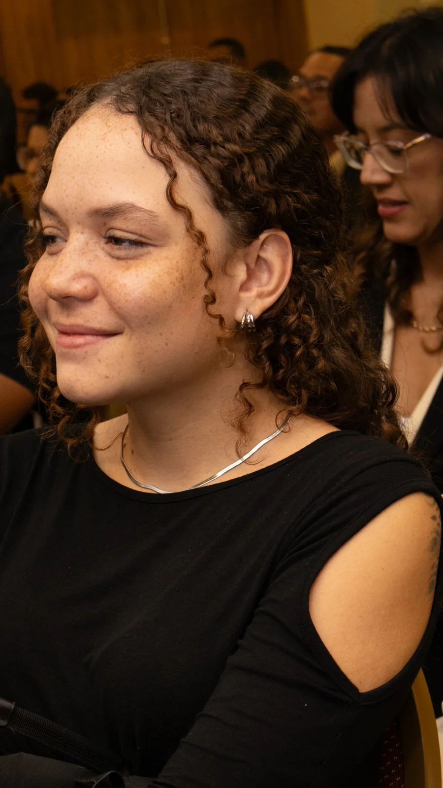 Participante sorrindo durante a palestra no BPE 2026